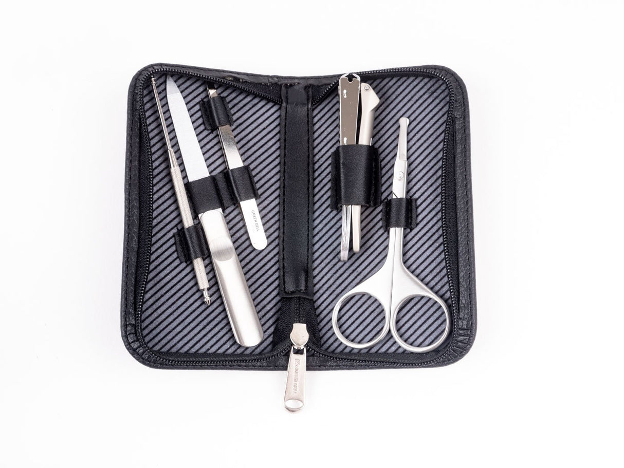 A travel grooming set by GreenBell Takumi No Waza, consisting of tweezers, nail clippers, nail files, scissors, and earpicks, displayed in an open black case with a striped pattern.