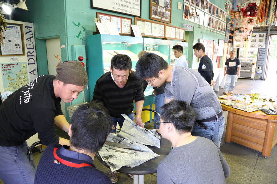 Craftsmen gathered around a table at Takefu Knife Village, October 2015