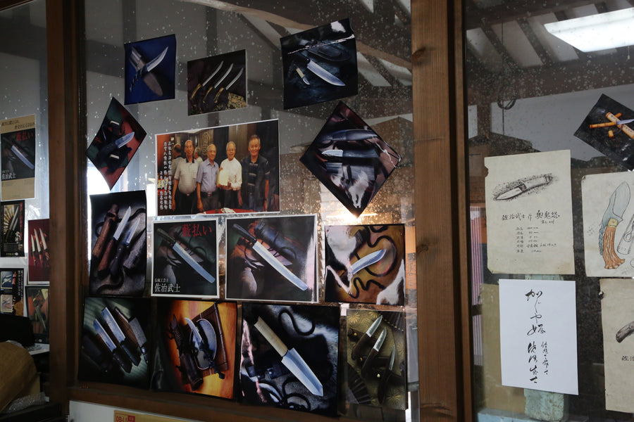 Knives and tools displayed in the Saji workshop window with craftsmen, Echizen