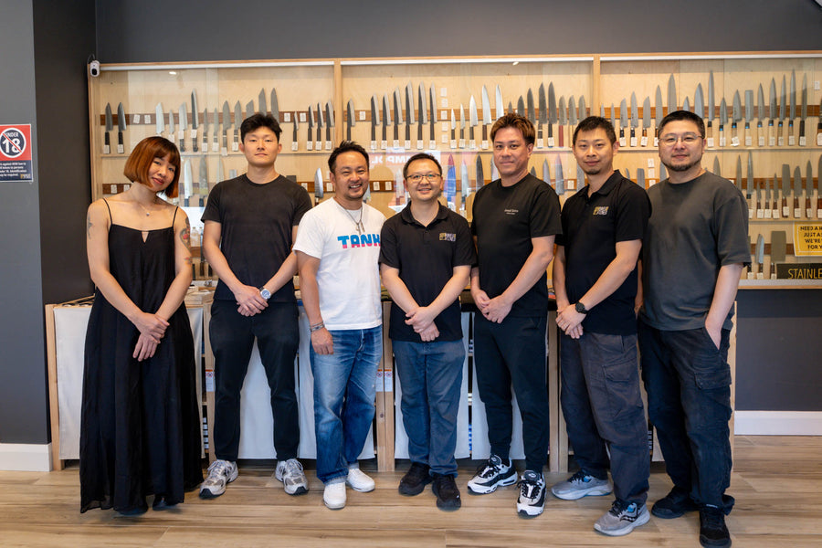 Takayuki Shibata with the Knives & Stones team in front of the knife wall, Sydney