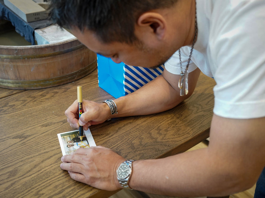 Shibata-san signing a photo print at the Knives & Stones Sydney store