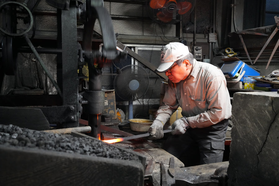 Itsuo Doi tends steel in the charcoal forge, December 2023.