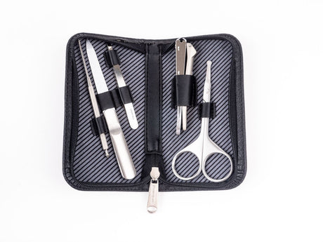 A travel grooming set by GreenBell Takumi No Waza, consisting of tweezers, nail clippers, nail files, scissors, and earpicks, displayed in an open black case with a striped pattern.